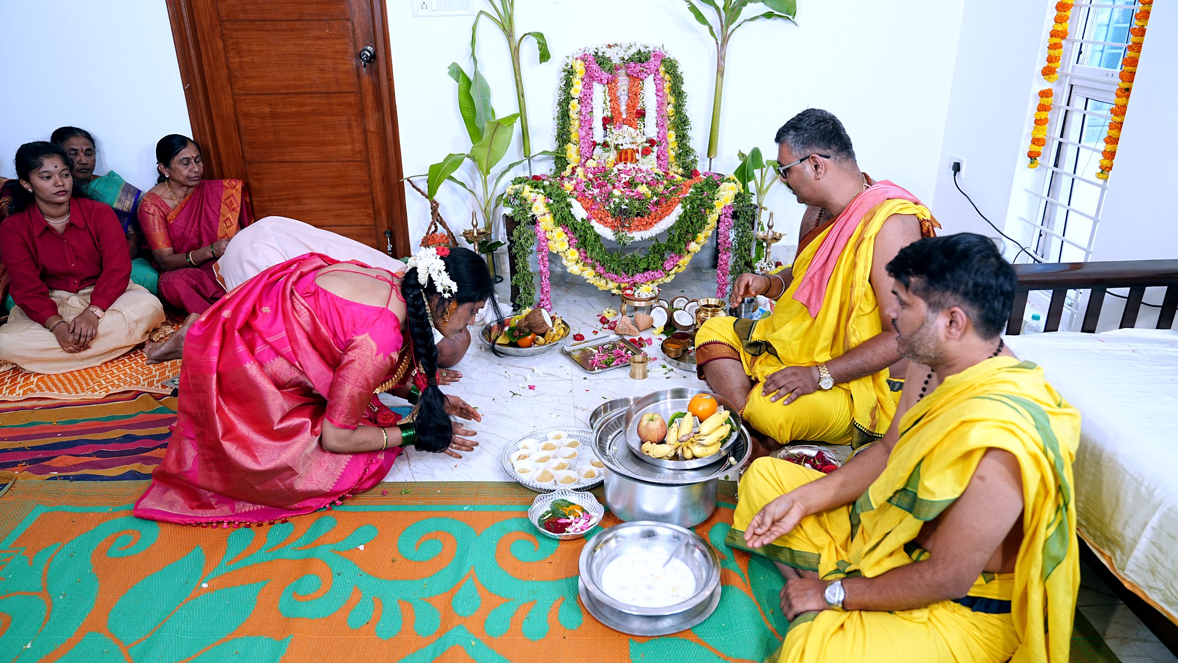 Candid ritual action moment during the Griha Pravesha ceremony