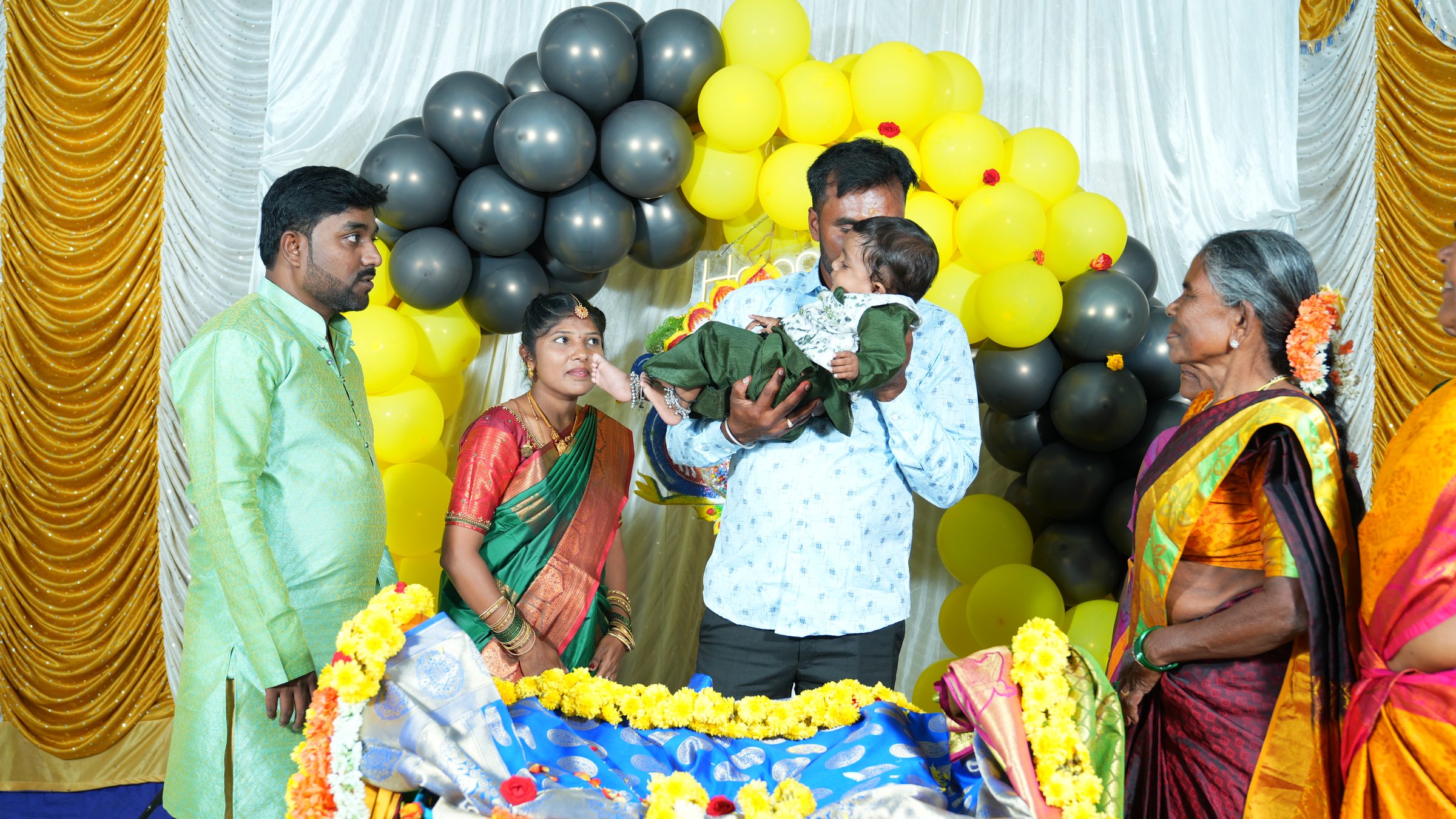 Father tenderly holding his baby during a naming ceremony