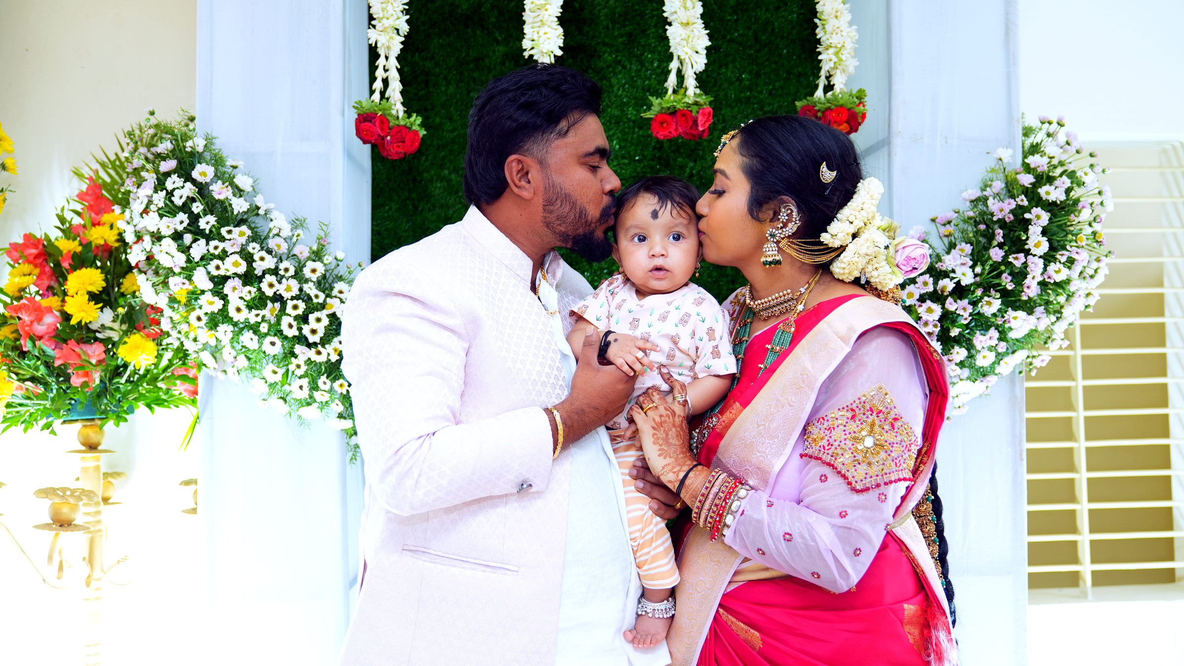 Baby photographed gently during a family ceremony in Bangalore by Lumeora Studios